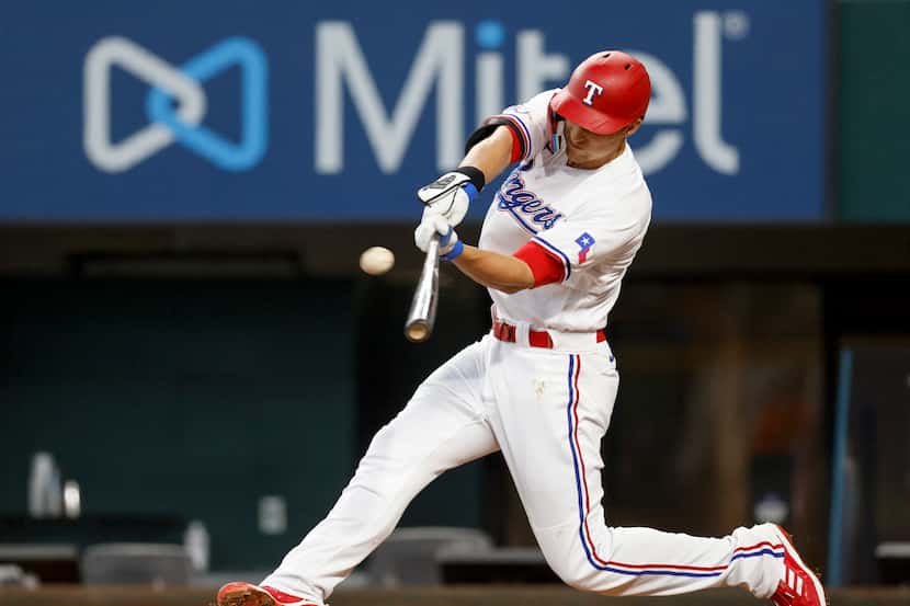 Texas Rangers shortstop Corey Seager (5) hits a two-run home run during the first inning of...