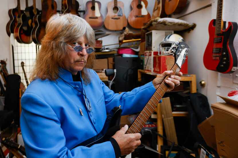 John Gasperik, a lifelong music memorabilia collector poses for a portrait with one of his...