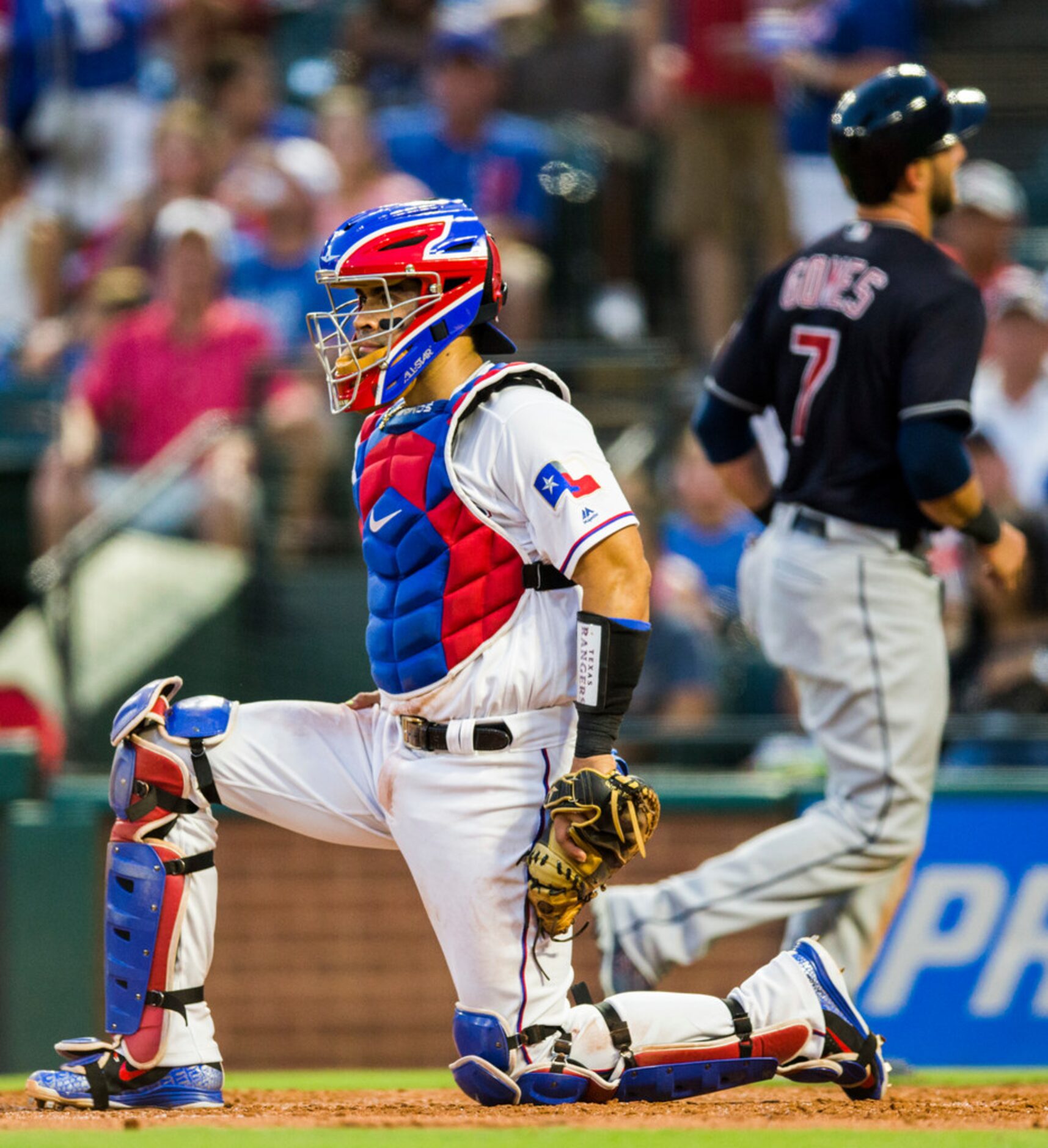 Texas Rangers catcher Robinson Chirinos (61) reacts to a run by Cleveland Indians catcher...