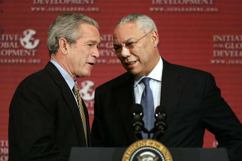 President Bush is greeted by former Secretary of State Colin Powell before making remarks at...