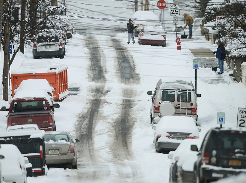 Residents clear the snow on Carmalt Street in Dickson City, Pa., on Thursday, Feb. 9, 2017....