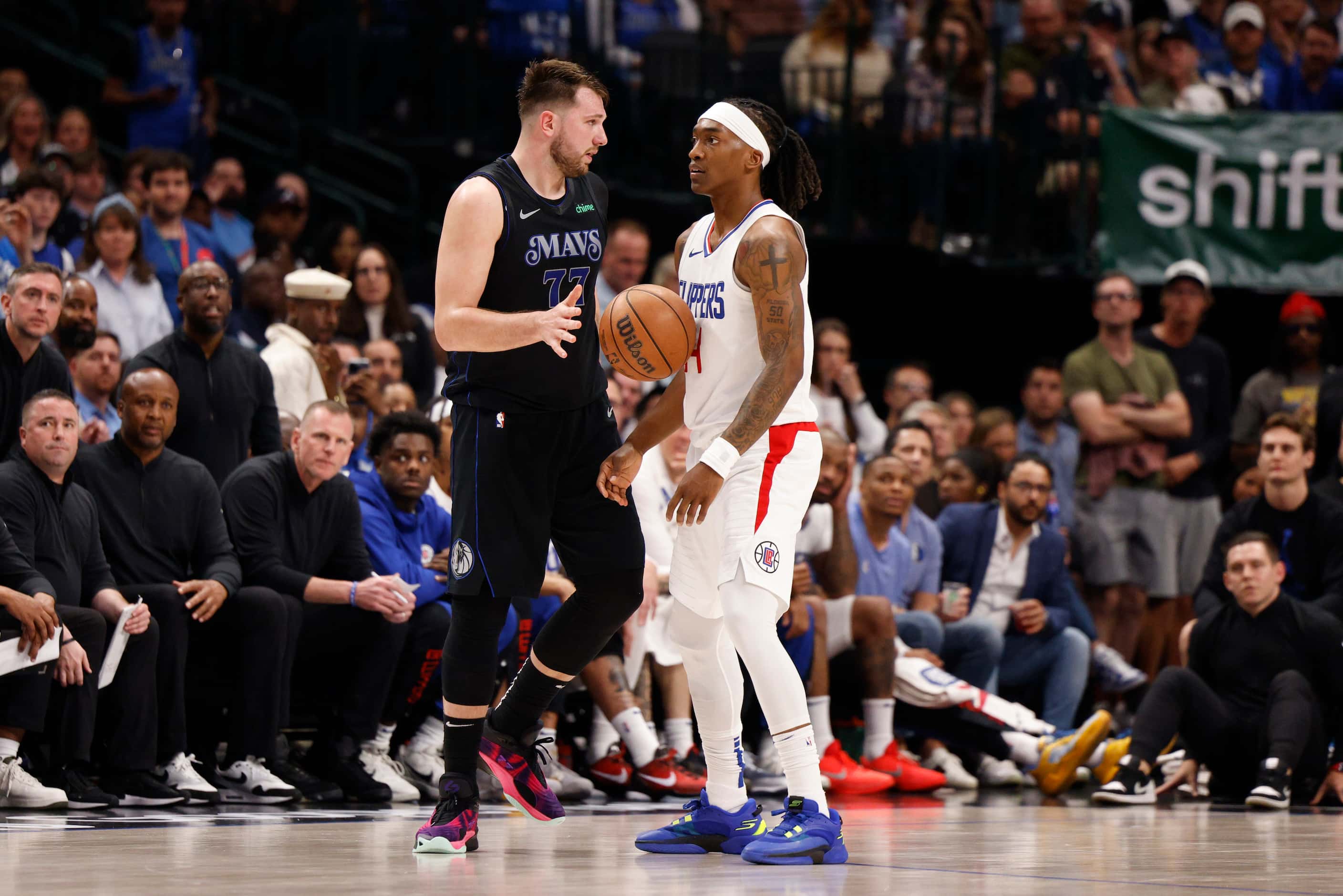 Dallas Mavericks guard Luka Doncic (77) drops the ball against the chest of LA Clippers...
