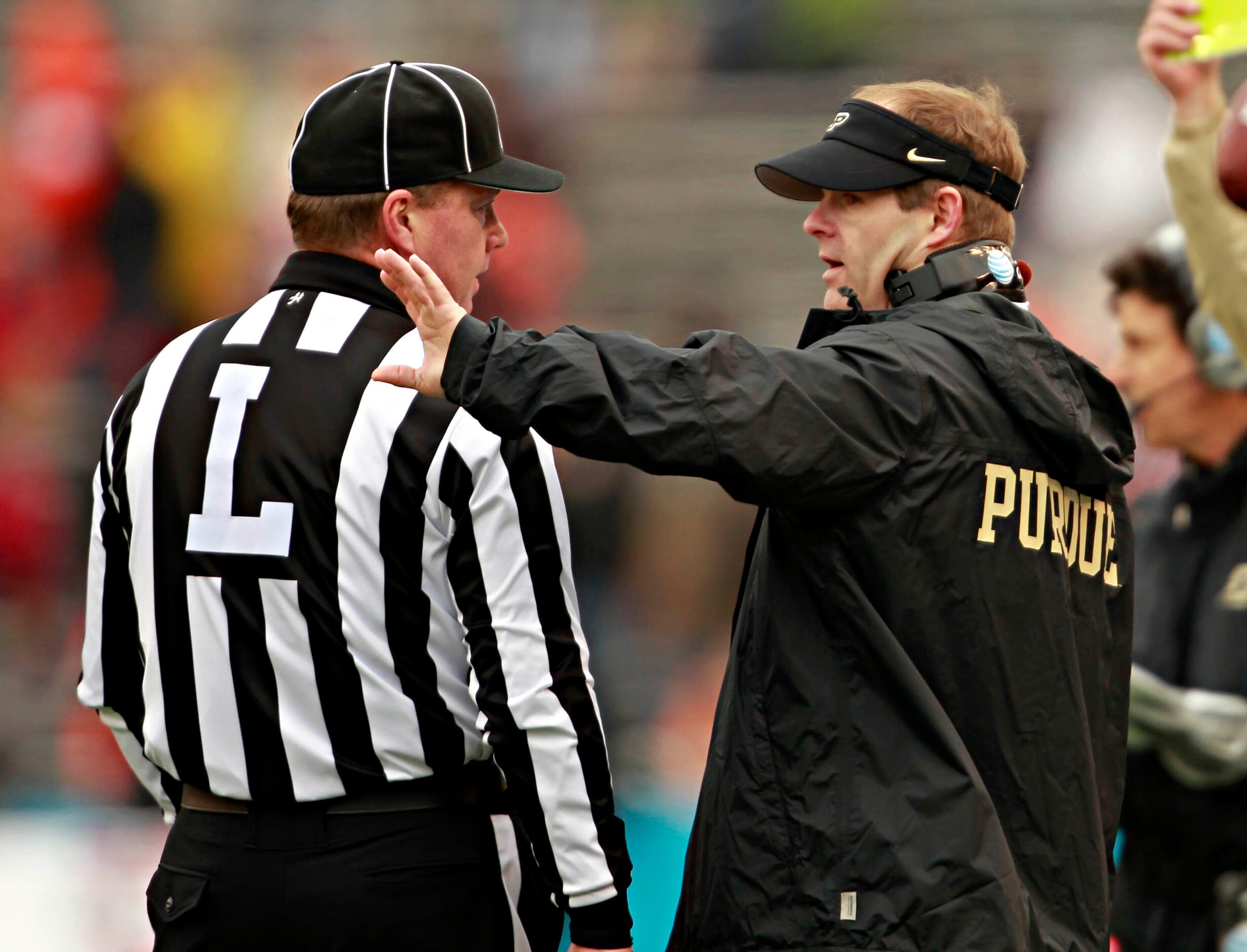 Purdue Boilermakers interim head coach Patrick Higgins (right) talks with line judge Tim...