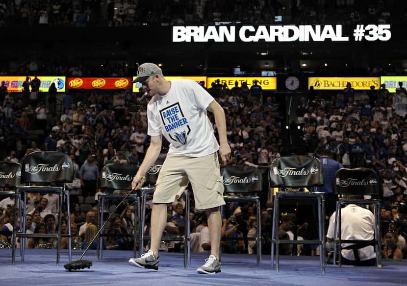 Brian Cardinal, known by the nickname "The Custodian," jokingly uses a carpet sweeper during...