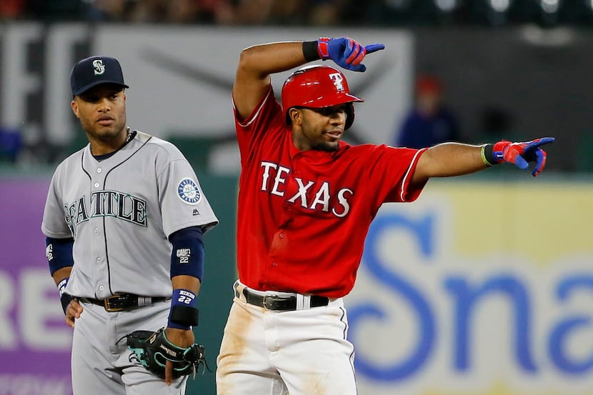Seattle Mariners second baseman Robinson Cano, left, watches as Texas Rangers' Elvis Andrus,...