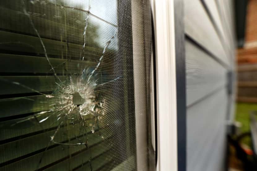 A bullet hole from the police officer's shot is seen in the rear window of Atatiana...