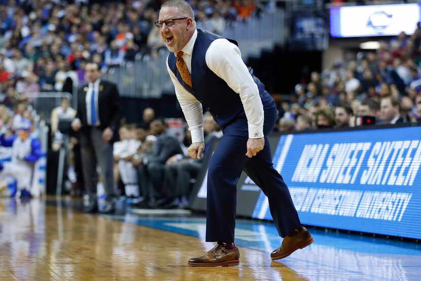 Virginia Tech coach Buzz Williams yells across the court to his players during the first...