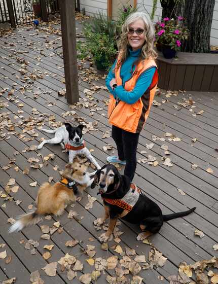 Bonnie McCririe-Hale with her dogs, Idabel, a black and tan coon hound; Buck, a pointer pit...
