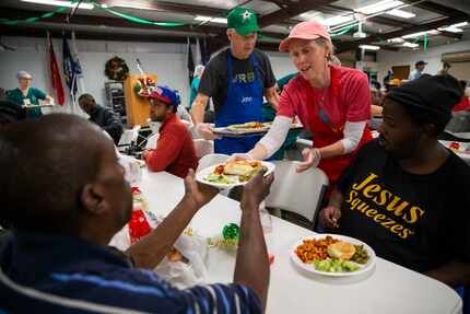 Kristi Mann, a volunteer from Valley Ranch Baptist Church in Coppell, helps serve the lunch...