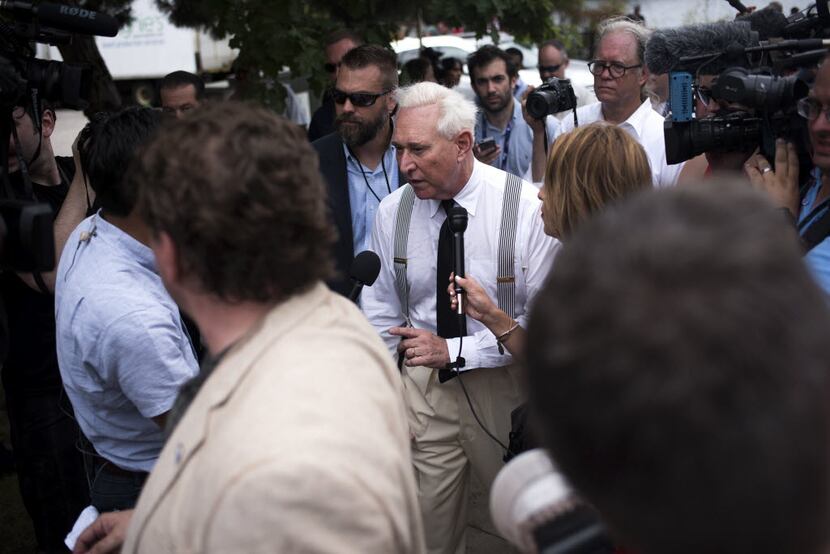 Trump friend and adviser Roger Stone walks off stage after speaking at rally in support of...