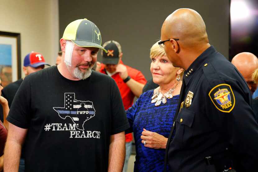 Fort Worth police Officer Matt Pearce (left), who was shot in March, came to John Peter...