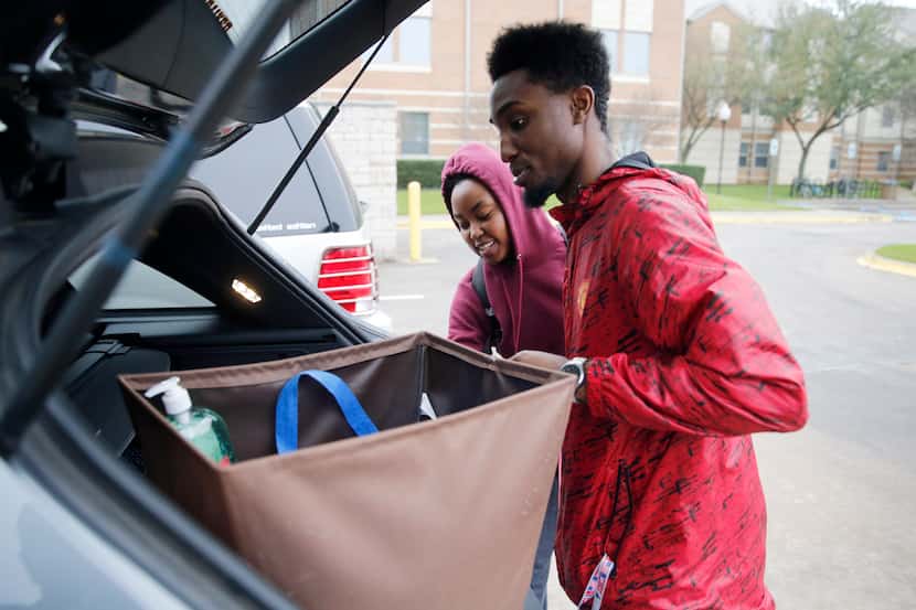 Engineering students Justin Battle and Tiara Lewis of Arlington pack up items to move out...