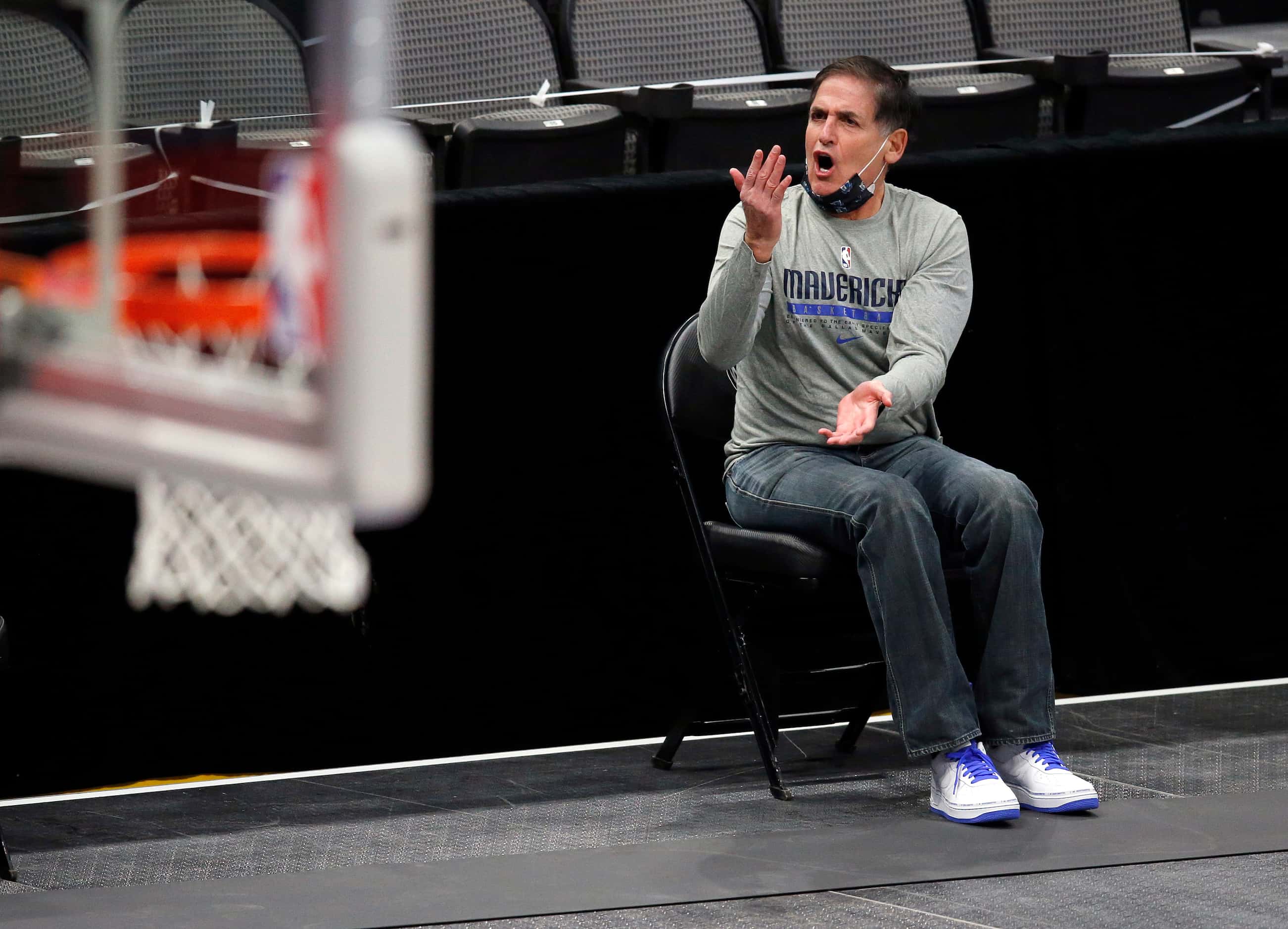 Dallas Mavericks owner Mark Cuban argues a call from his socially distanced seat along the...