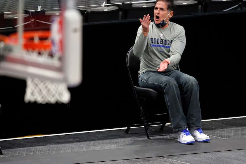 Dallas Mavericks owner Mark Cuban argues a call from his socially distanced seat along the...