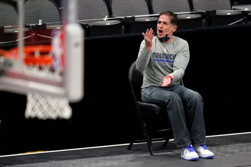 Mavericks owner Mark Cuban argues a call from his socially distanced seat along the sideline...