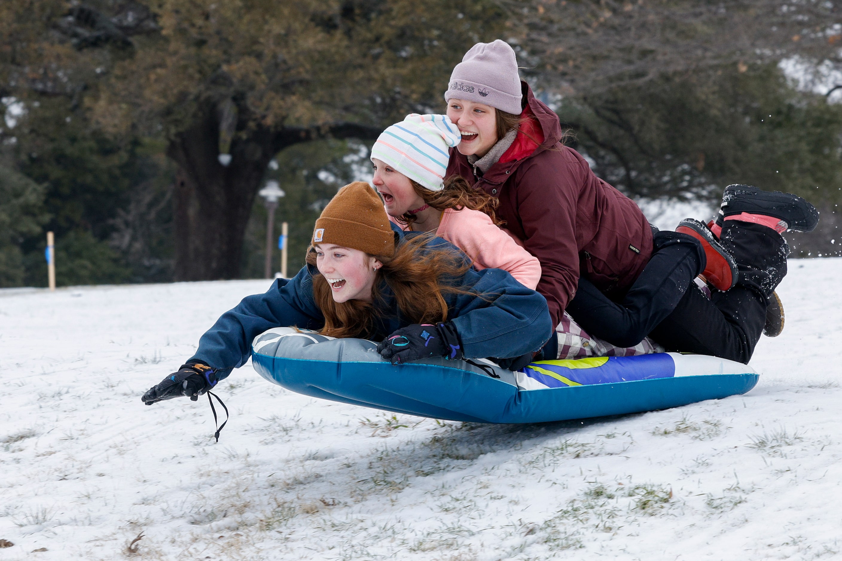 Claire Laviolette, 19 (left), Jojo Kisser, 8 (middle), and Jaycee Kisser, 8, catch some air...