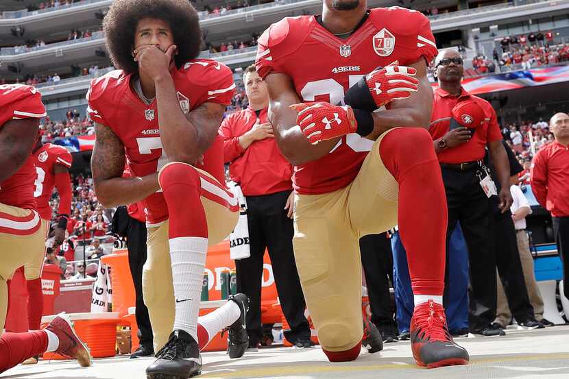 FILE - In this Oct. 2, 2016 file photo, San Francisco quarterback Colin Kaepernick, left,...