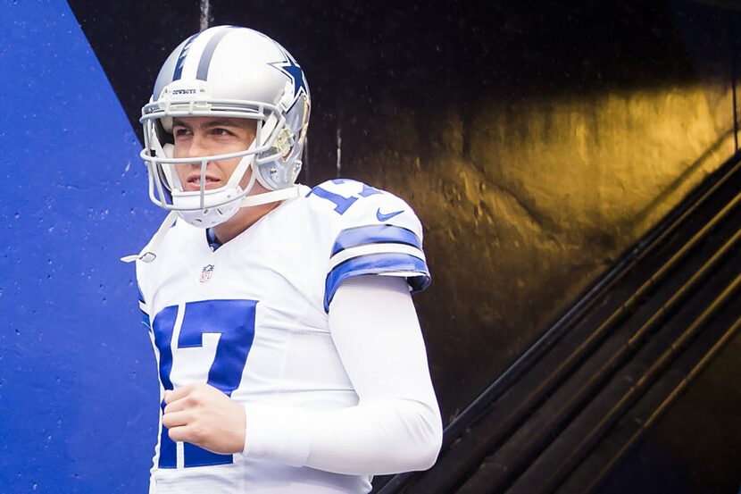 Dallas Cowboys quarterback Kellen Moore takes the field to warm up before an NFL football...