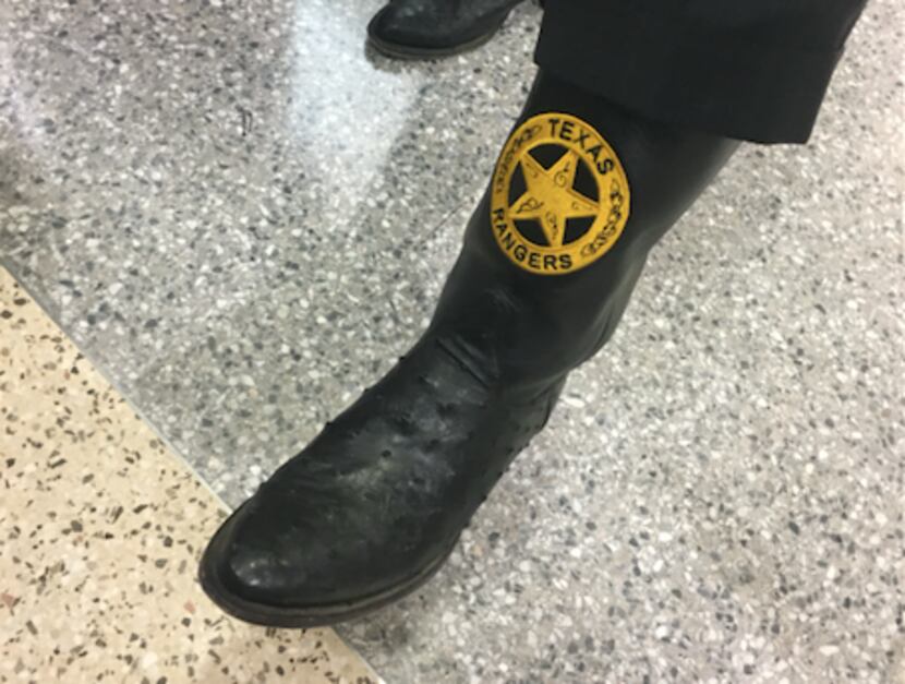 Special prosecutor Brian Wice lifted his pant leg to show the custom Texas Rangers boots he...