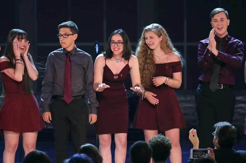 Students from the Marjory Stoneman Douglas High School drama department react after...