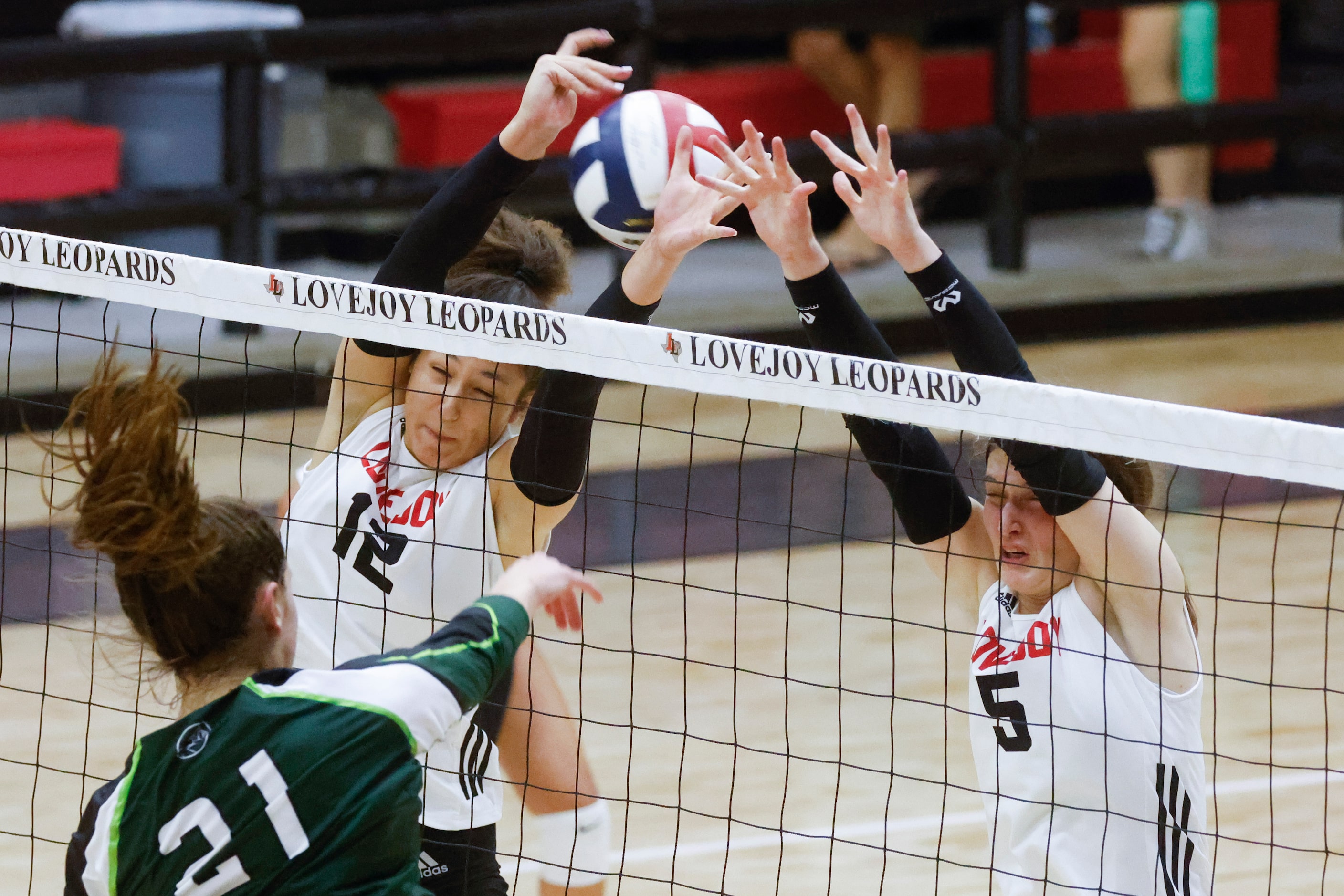 Prosper’s Ayden Ames (21) digs the ball past Lovejoy’s Hannah Gonzalez, left, and Morgan...