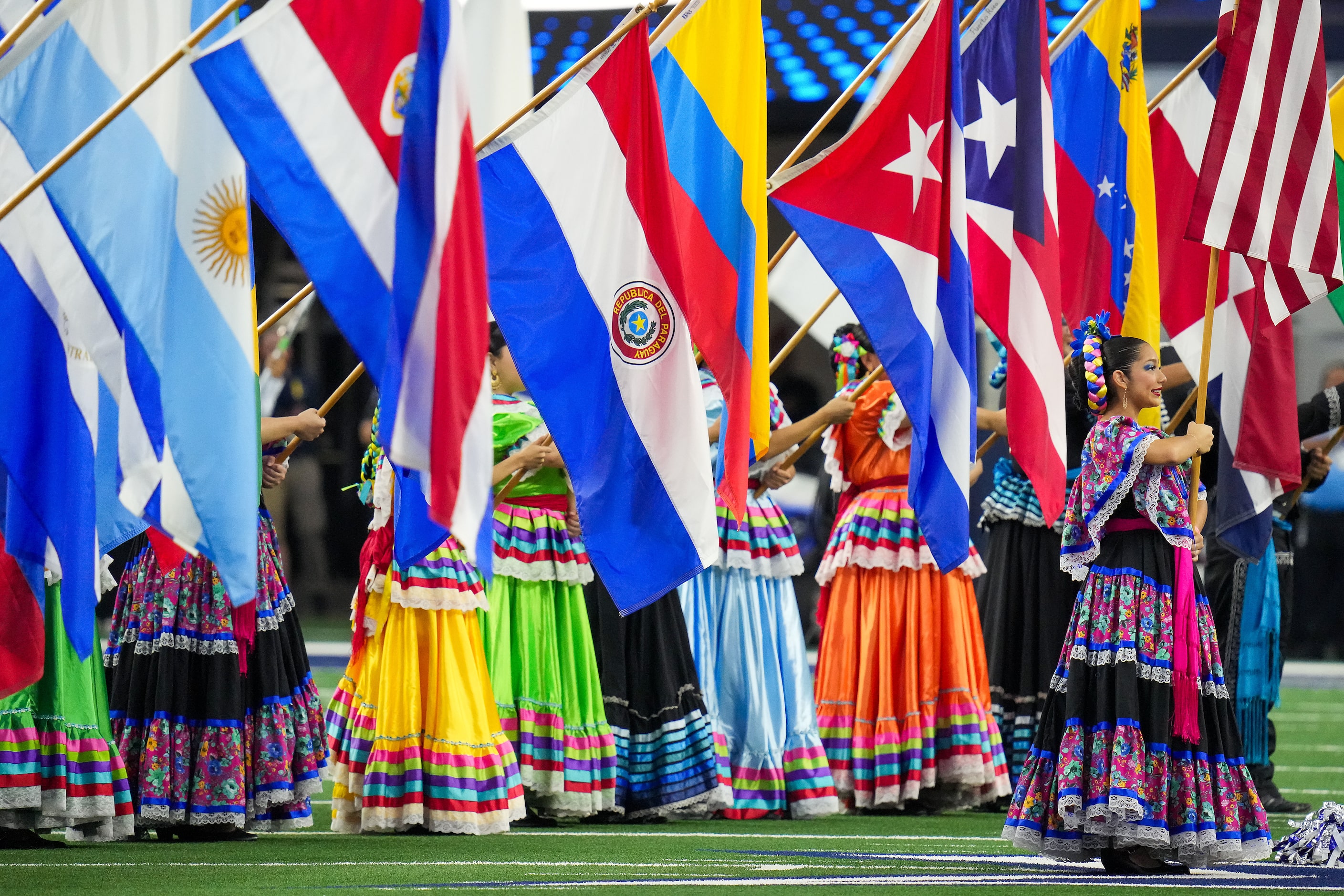 Folklorico dancers present the colors before an NFL football game between the Dallas Cowboys...