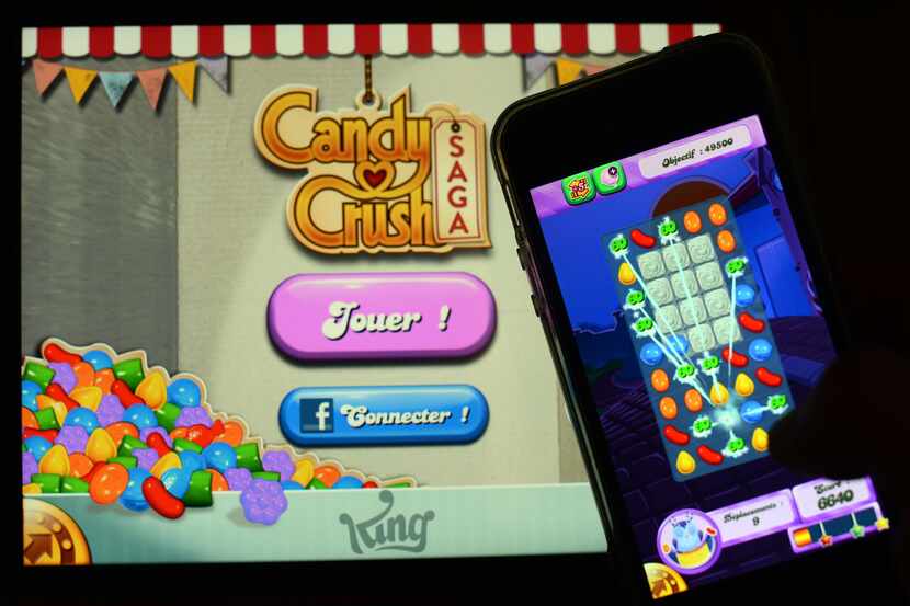 (Files) In this file picture taken on January 25, 2014, a man plays Candy Crush Saga on his...