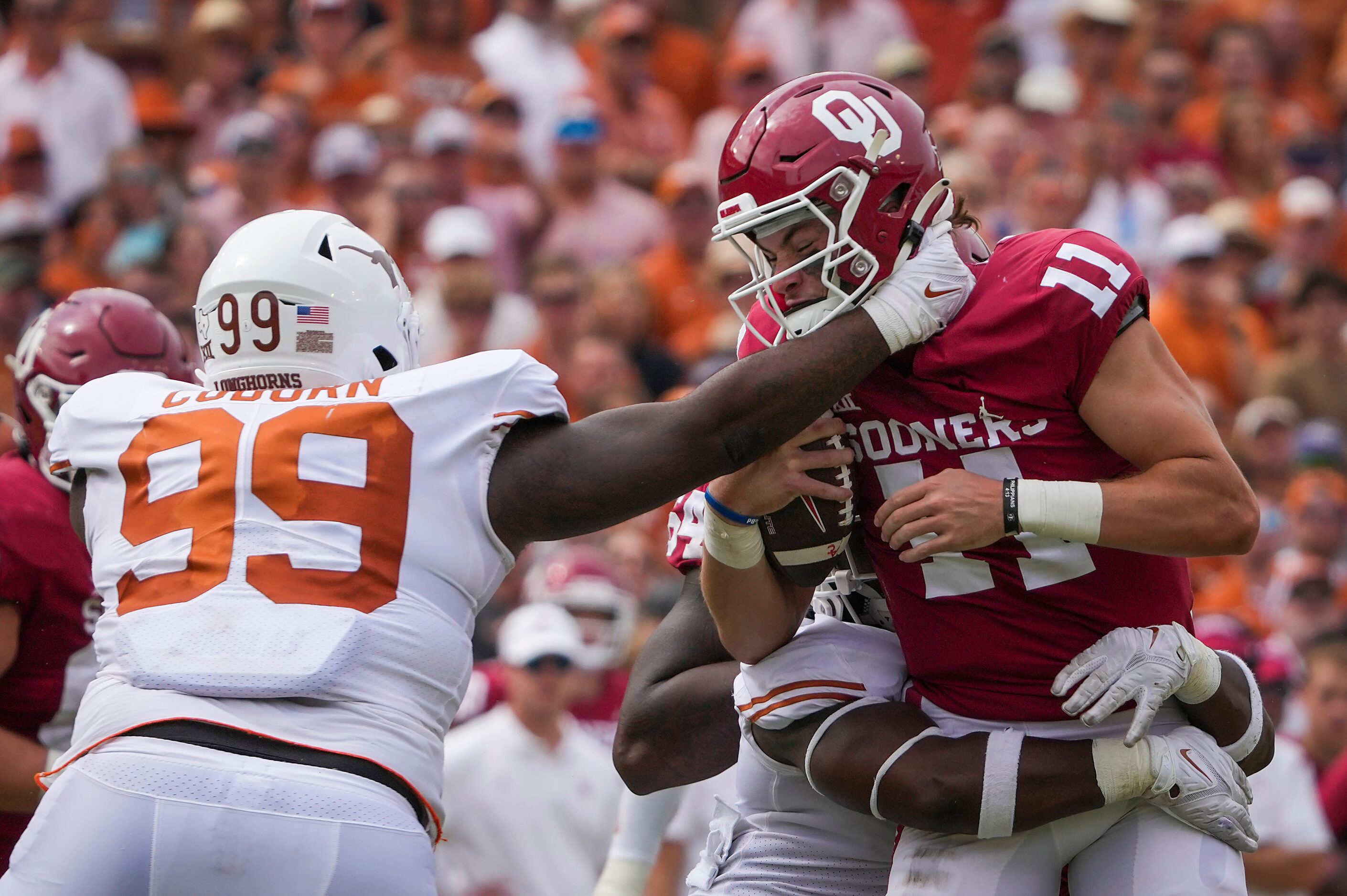 Oklahoma quarterback Davis Beville (11) is sacked by Texas defensive end Justice Finkley (1)...