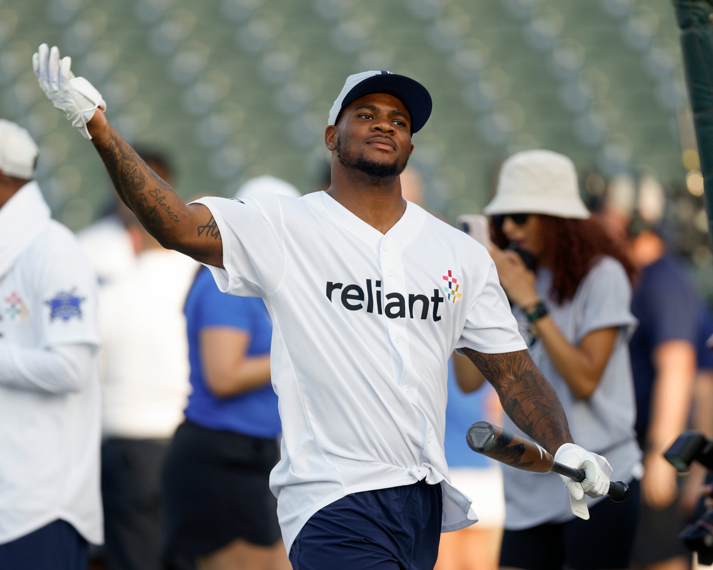 Dallas Cowboys linebacker Micah Parson pumps up the crowd before an at bat during the...