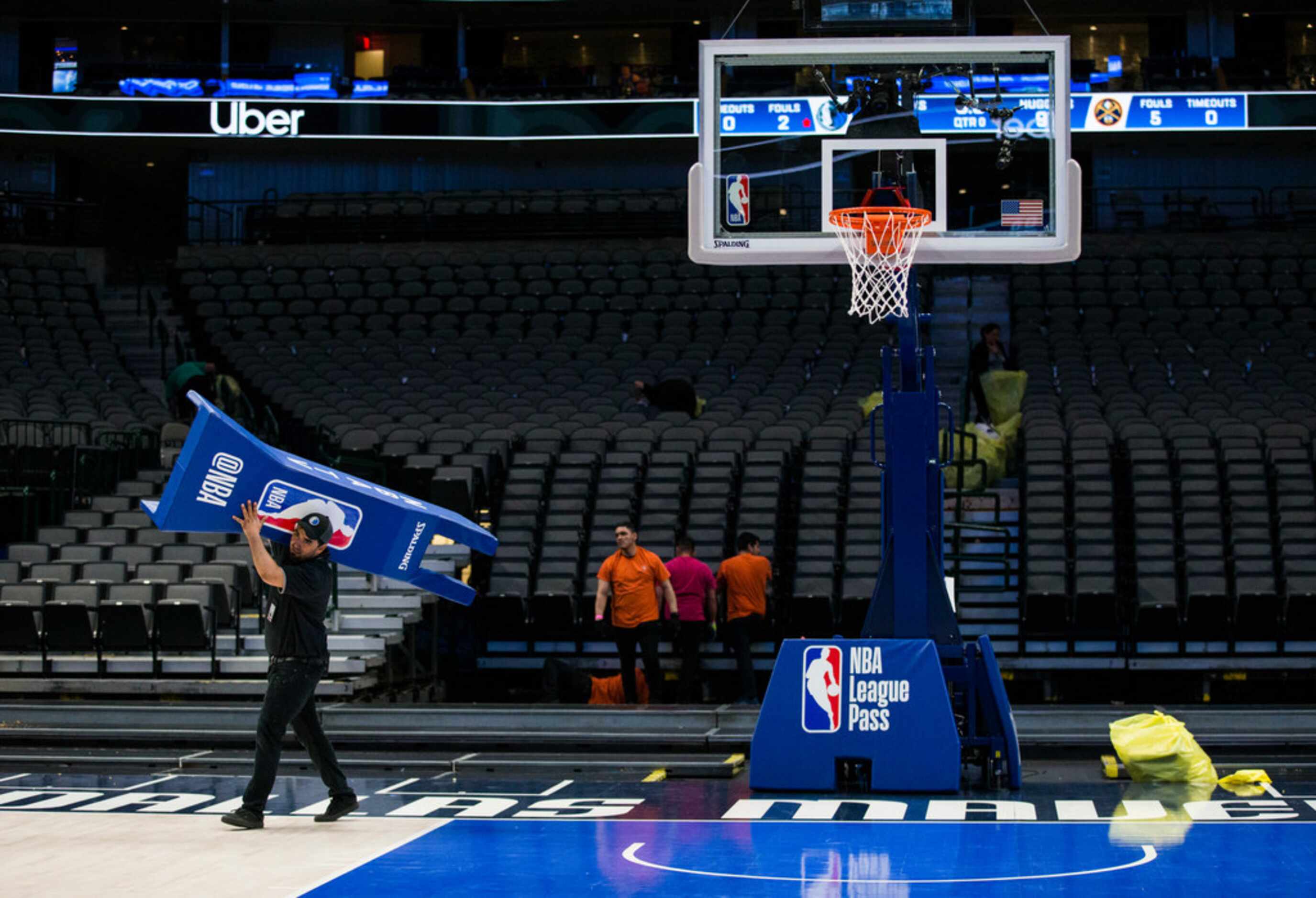 Crews break down the court after the Dallas Mavericks beat the Denver Nuggets 113-97 on...