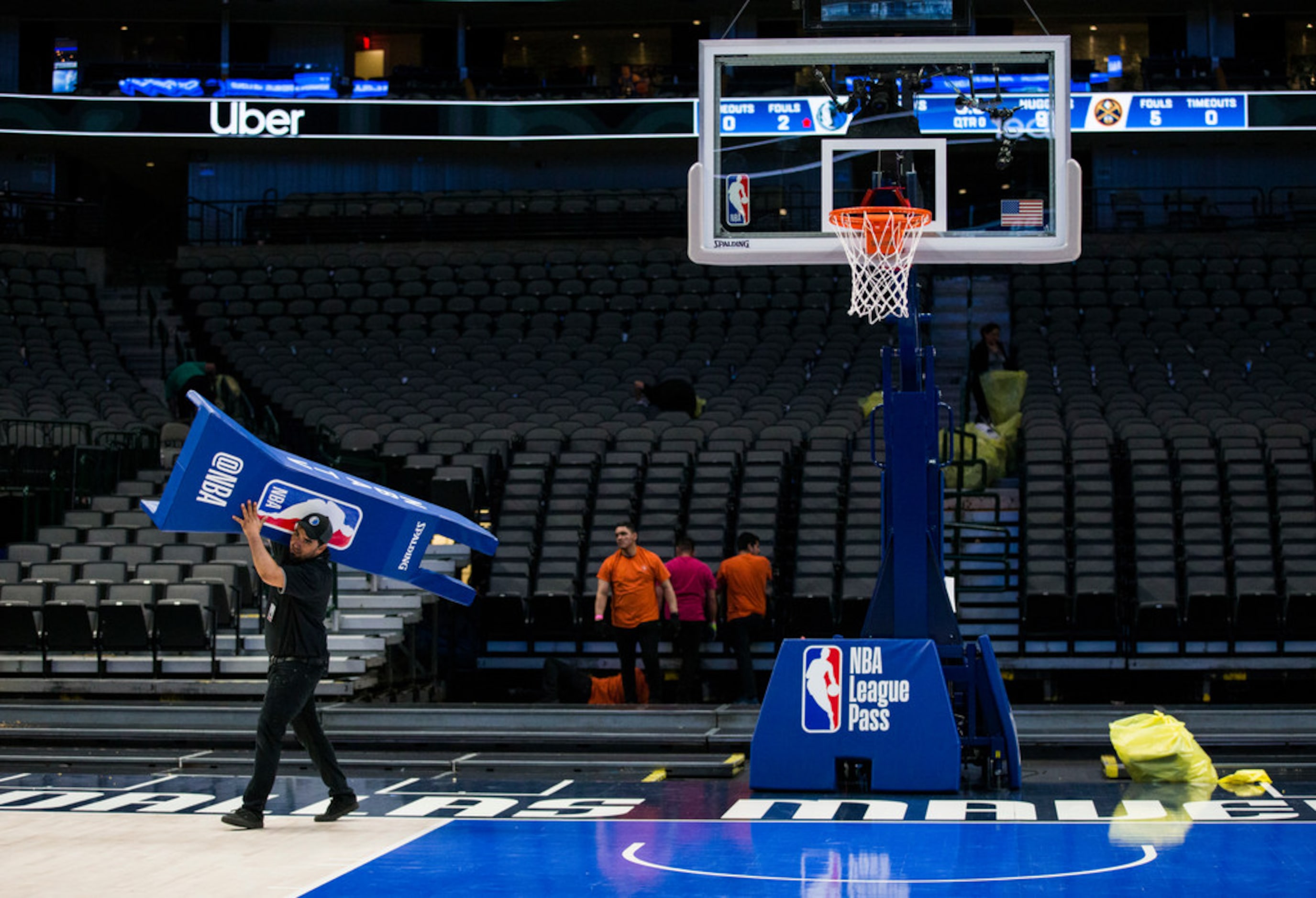 Crews break down the court after the Dallas Mavericks beat the Denver Nuggets 113-97 on...