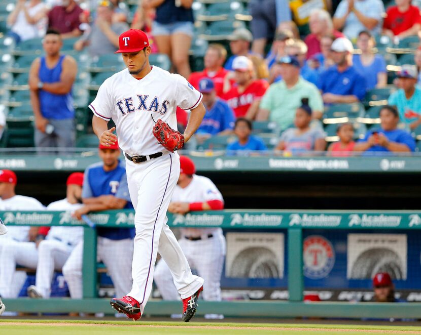 Texas Rangers starting pitcher Yu Darvish runs to the mound to face the Miami Marlins in the...