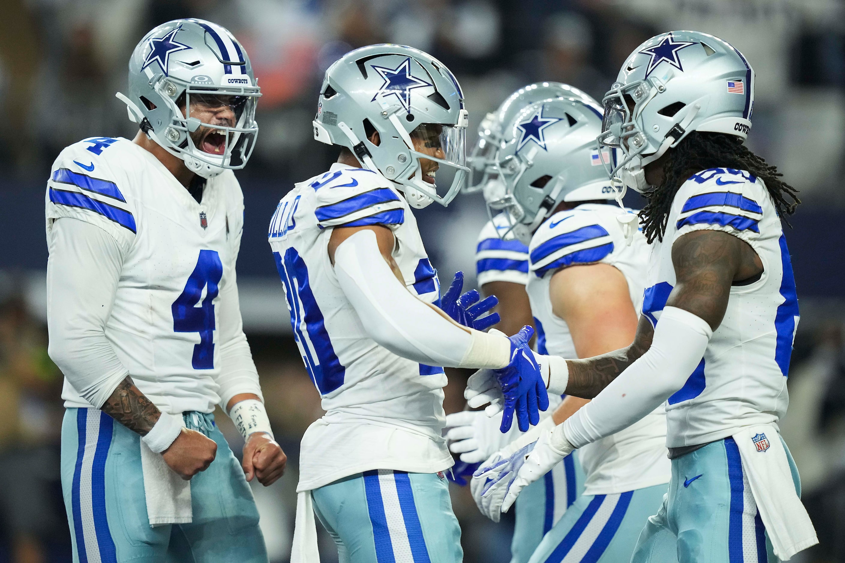 Dallas Cowboys quarterback Dak Prescott (4) celebrates with running back Tony Pollard (20)...