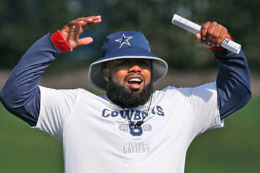 Dallas Cowboys running back Ezekiel Elliott reacts to the action on the field during the...