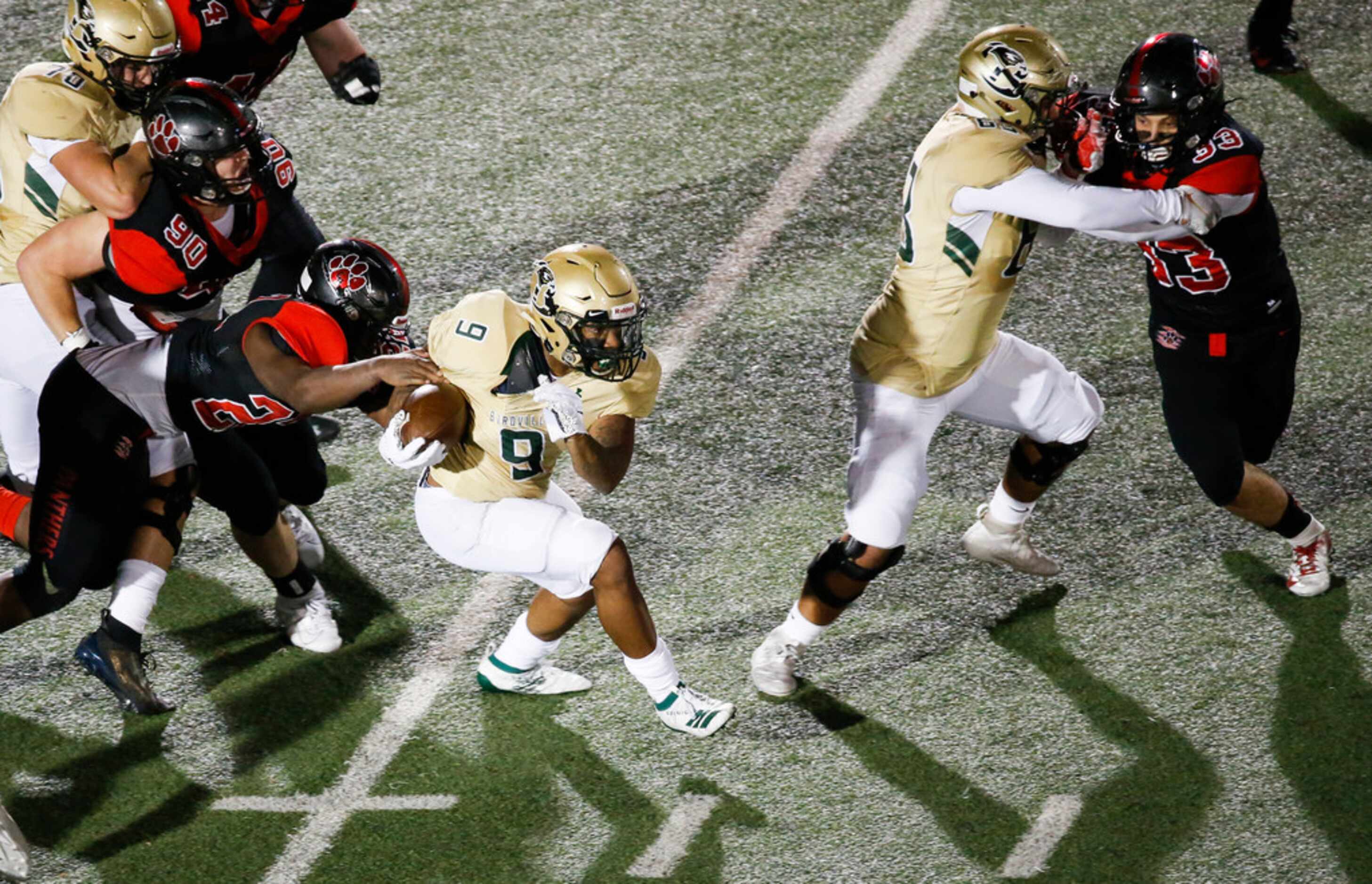 Birdville running back Laderrious Mixon (9) pulls free from Colleyville Heritage offensive...