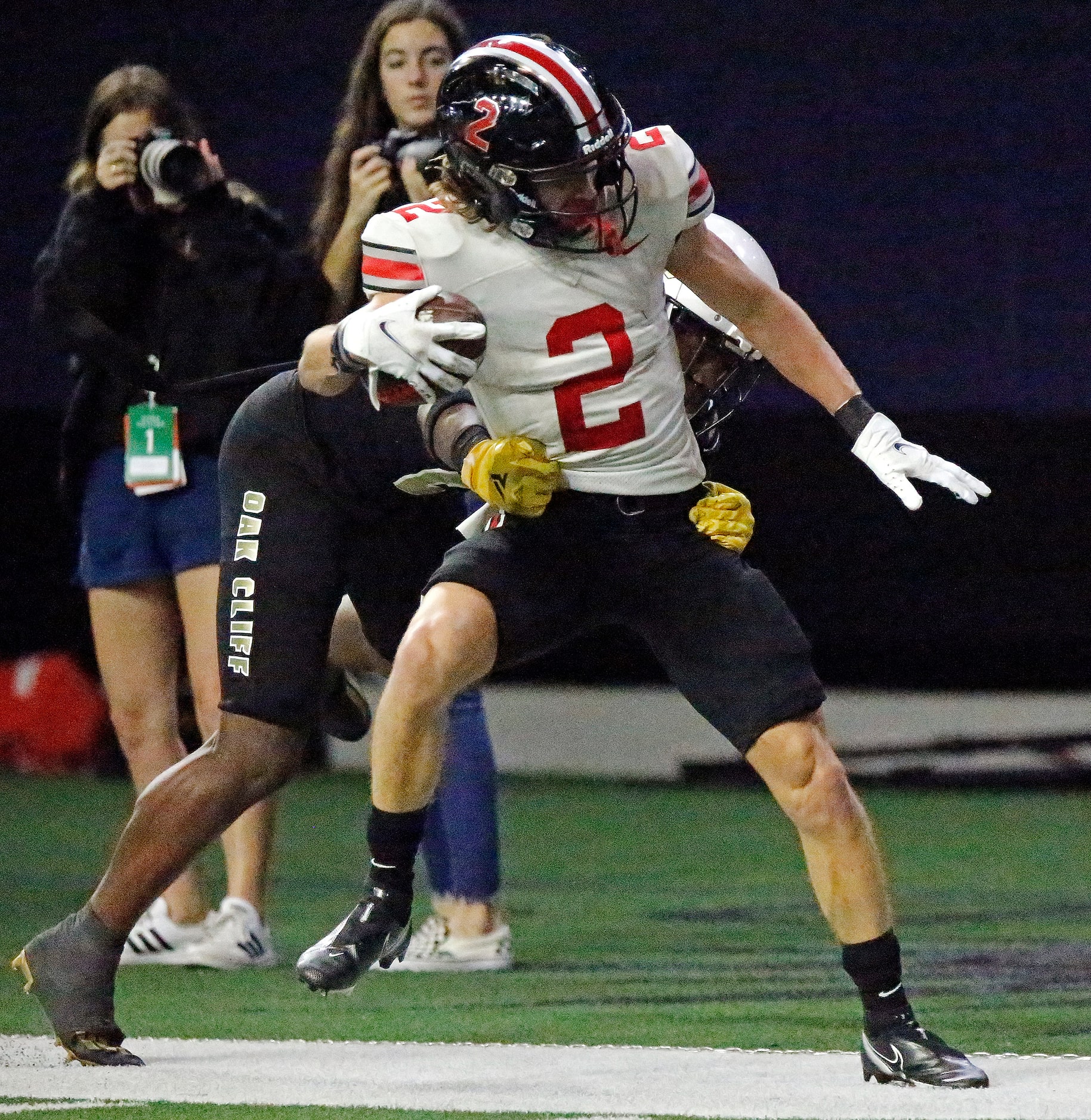 Lovejoy High School wide receiver Jaxson Lavender (2) is wrestled out of bounds by South Oak...