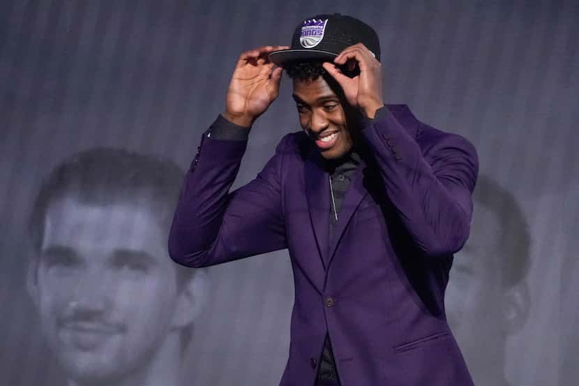 Olivier-Maxence Prosper dons a Sacramento Kings cap after being selected 24th overall by the...