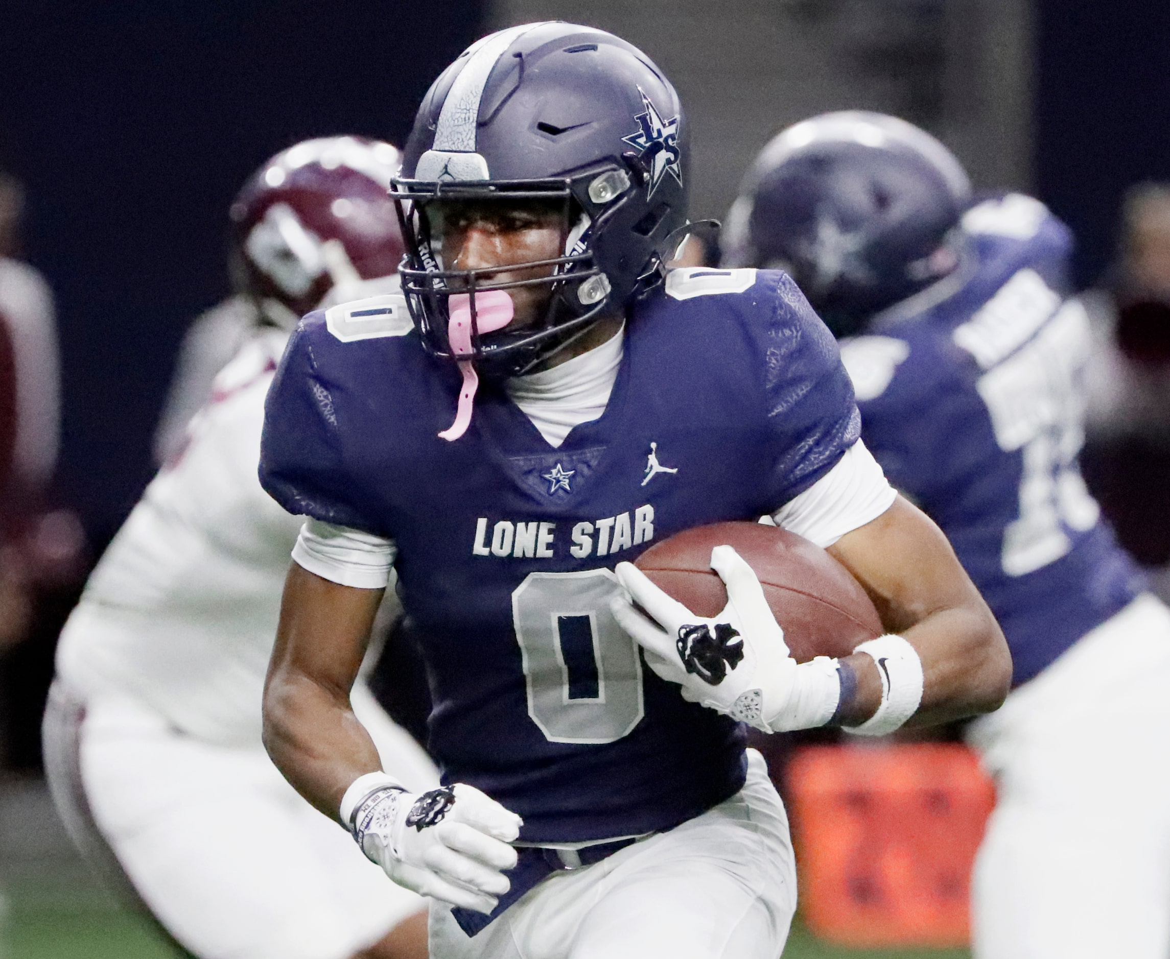 Lone Star High School running back Davian Groce (0) runs for a touchdown during the first...