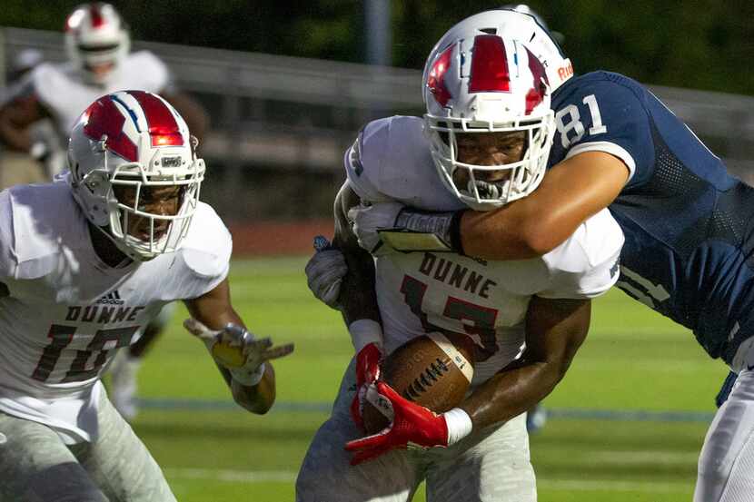 All Saints' Episcopal tight end Mitchell Bothwell (81) tackles Bishop Dunne linebacker John...