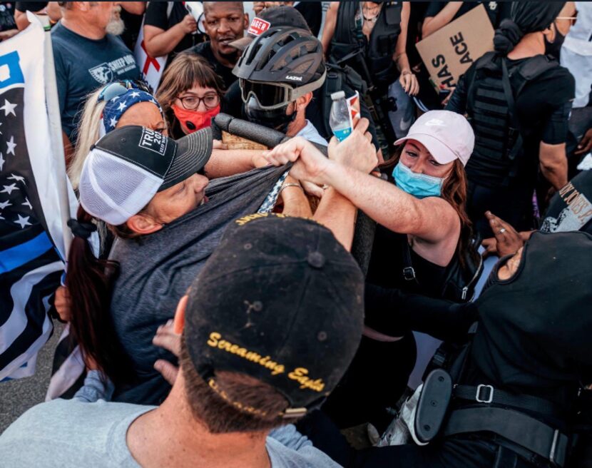 Police tried to keep both sides apart at a protest rally on July 25 at the Parker County...