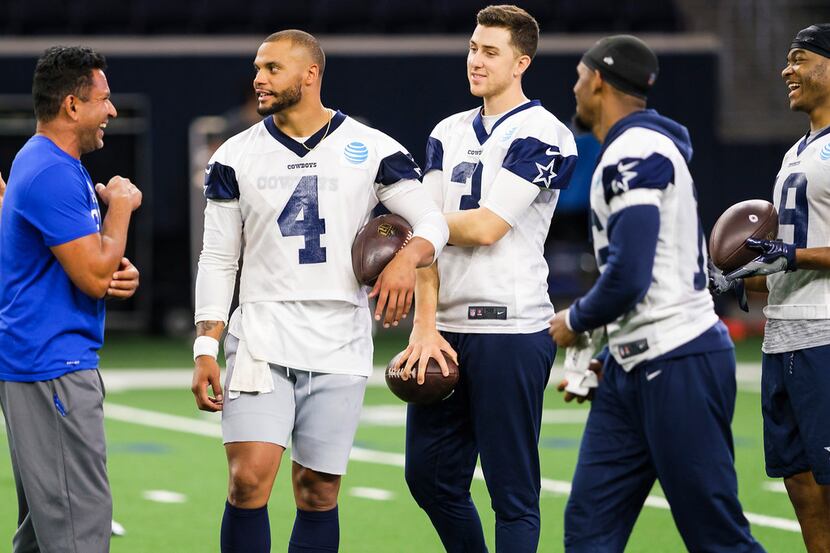 Dallas Cowboys quarterback Dak Prescott (4) laughs with (from left) wide receivers coach...
