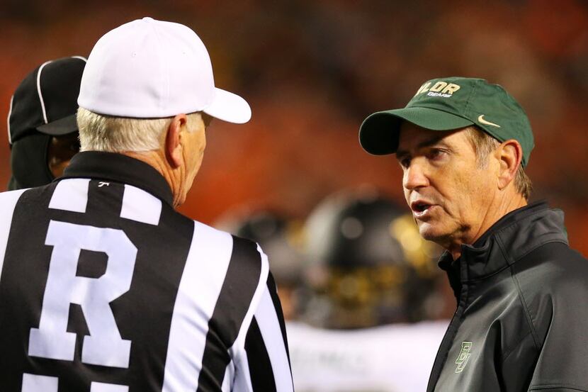 Head coach Art Briles of the Baylor Bears speaks with an official in the first quarter...