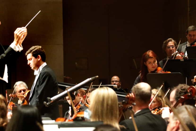 Guest conductor Gustavo Gimeno, left, leads the Dallas Symphony Orchestra in the Dallas...