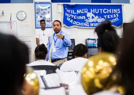 Wilmer-Hutchins High School band director Carlton Cooper helps his band rehearse after...
