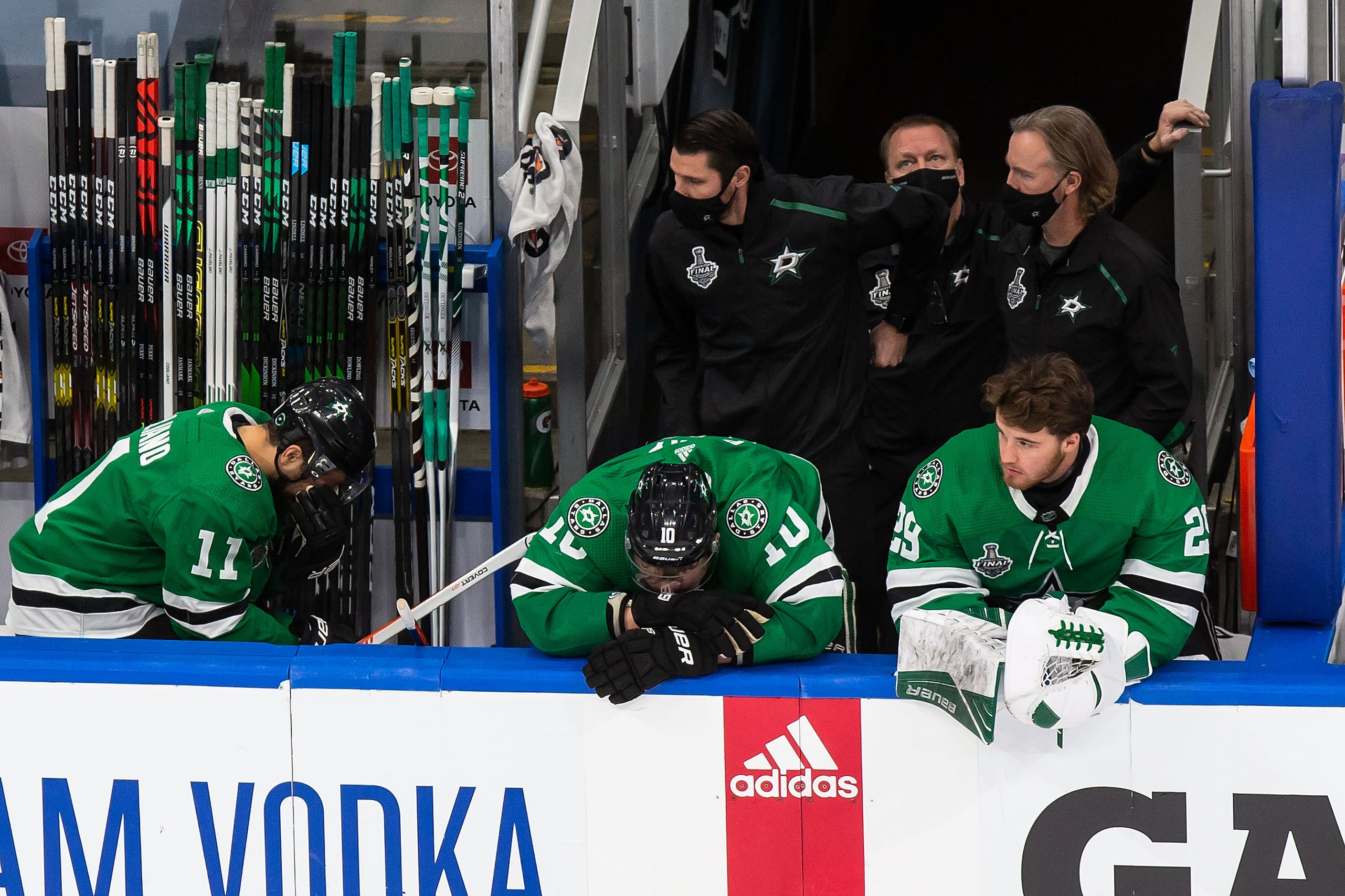 Andrew Cogliano (11), Corey Perry (10) and Jake Oettinger (29) of the Dallas Stars react to...