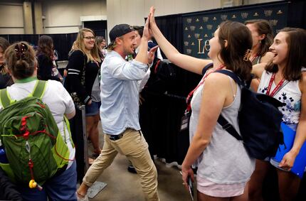 Draco Malfoy -- err, Harry Potter actor Tom Felton -- gives high-fives to fans before...