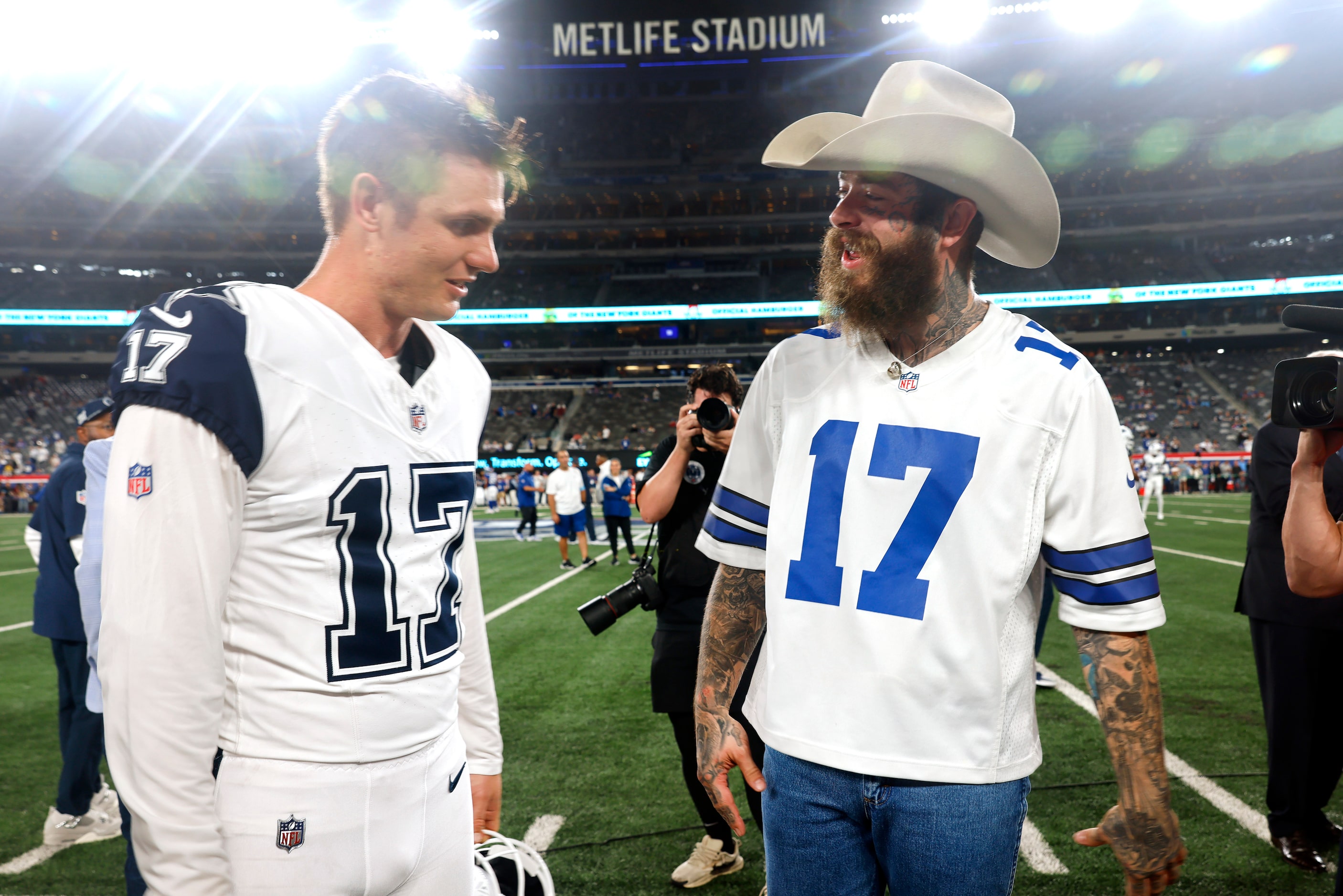 Rapper, singer and songwriter Post Malone (right) visits with Dallas Cowboys place kicker...