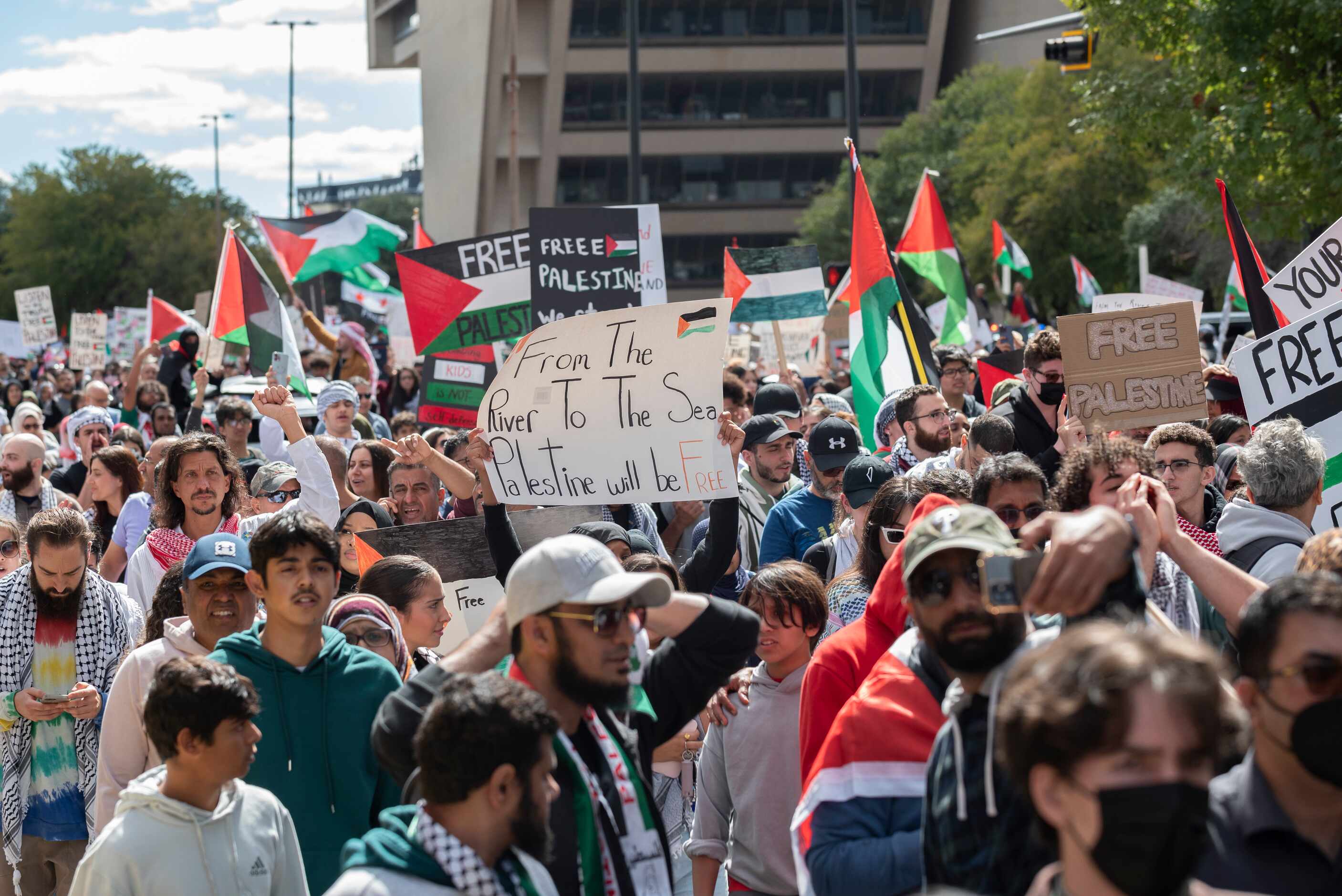 Palestine supporters march on Ervay Street during a protest titled "All Out for Palestine"...