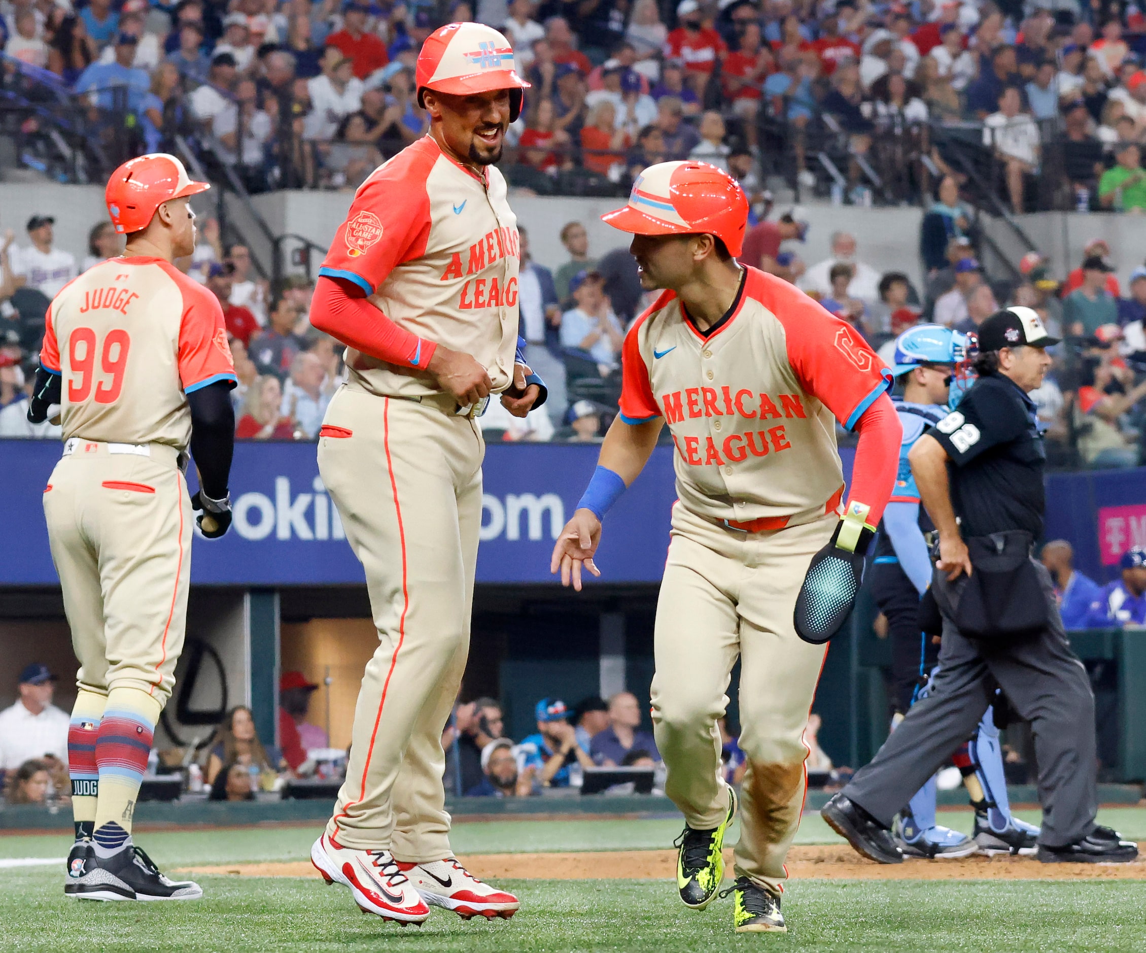 American League's Marcus Semien, of the Texas Rangers, (center) and American League's Steven...