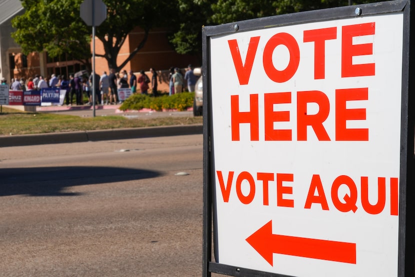 Voters wait in line outside the Haggard Library on the first day of early voting for the...